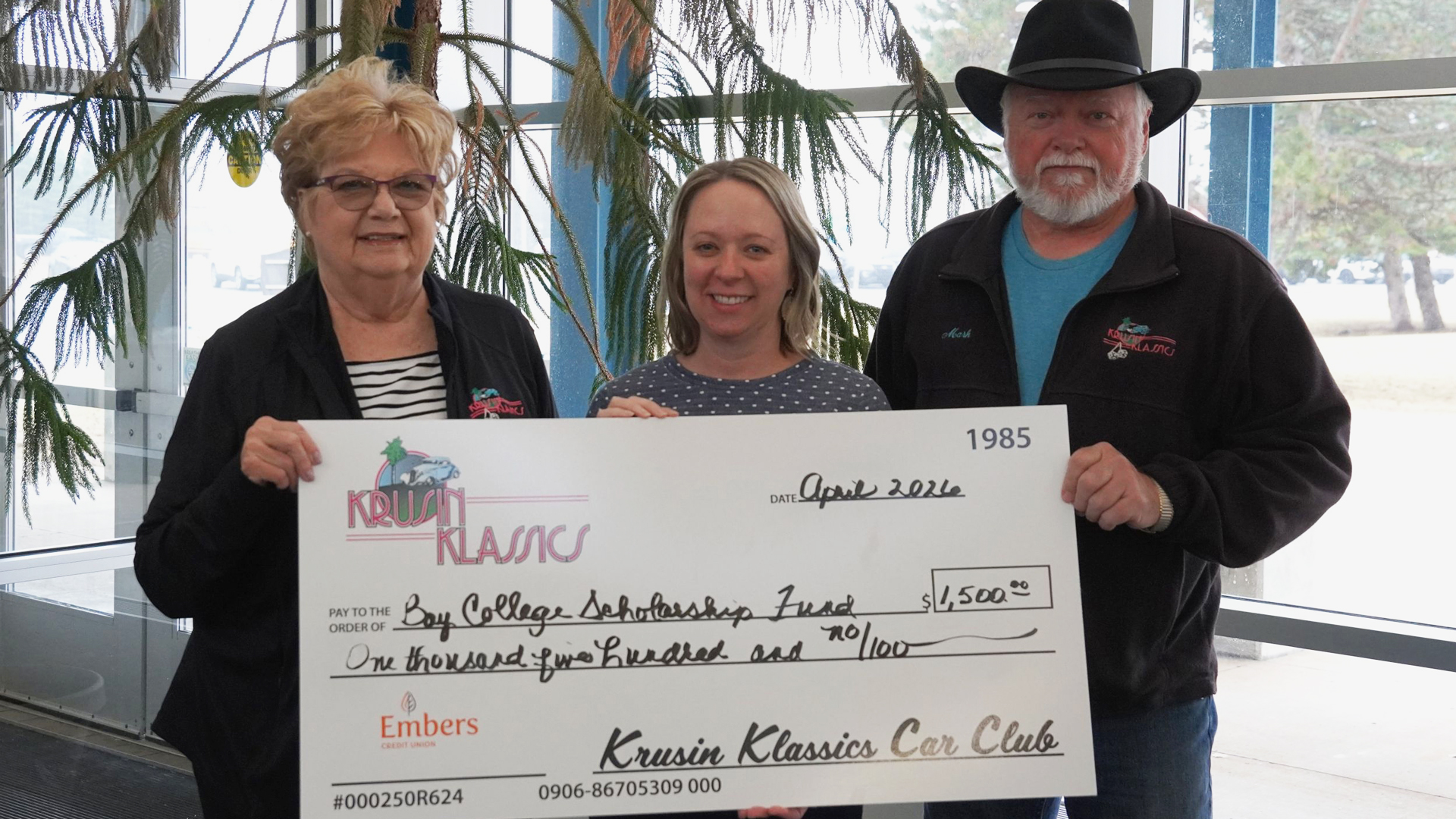 From left to right, Krusin' Klassics representative Janet Snowden, Bay College Foundation Executive Director Vicki DeGrand, and Krusin' Classics representative Mark Caswell hold up a giant check for $1,500 for the Bay College scholarship fund.