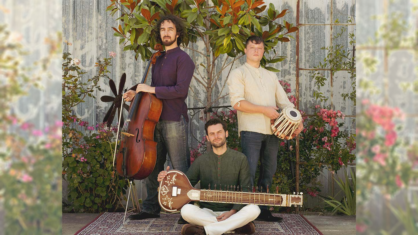 The members of the Will Marsh Integration Ensemble pose with their instruments in a garden.